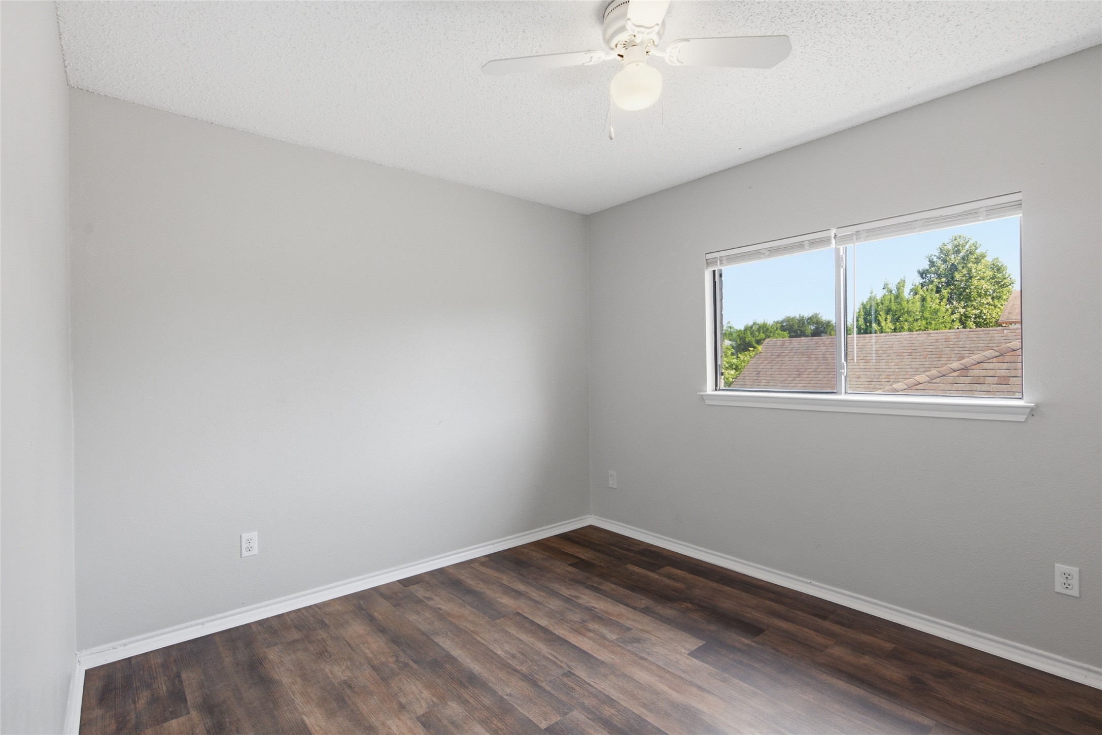 7900 Rosenberry Drive Austin, TX 78747 - Photo 17 of 27 A quiet retreat with a sun-filled window and modern wood flooring for peaceful living.