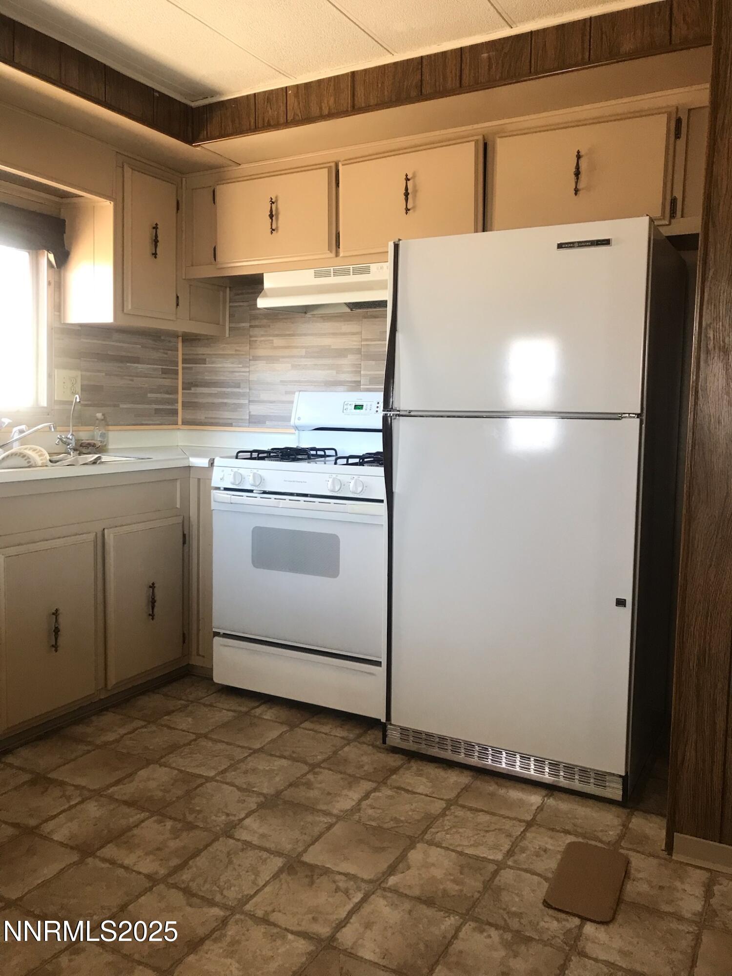 3791 Granite Way Topaz Ranch Estates, NV 89444 - Photo 14 of 39 a white refrigerator freezer sitting inside of a kitchen