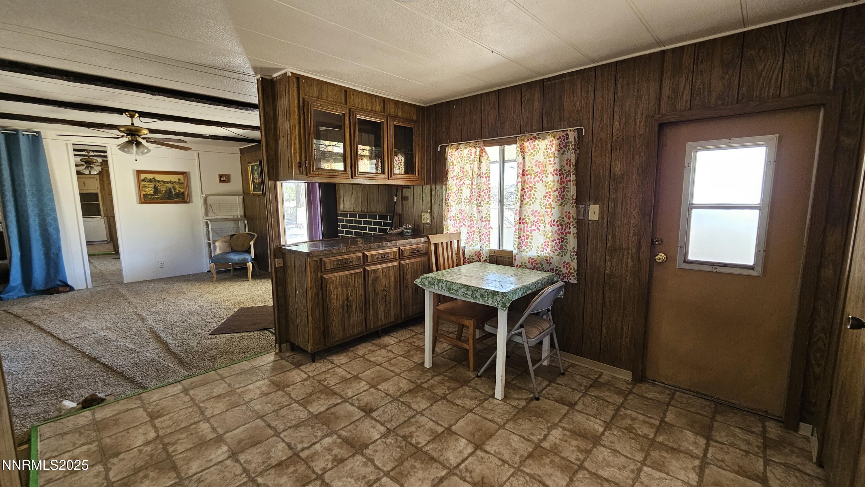 3791 Granite Way Topaz Ranch Estates, NV 89444 - Photo 17 of 39 a kitchen with a refrigerator a stove top oven a sink dishwasher and dining table with wooden floor