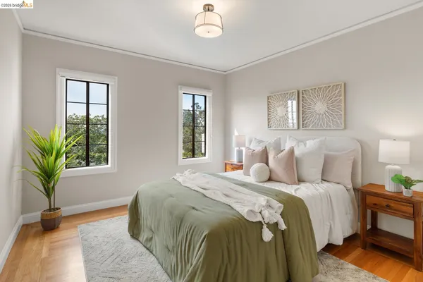 a bedroom with bed and a large window