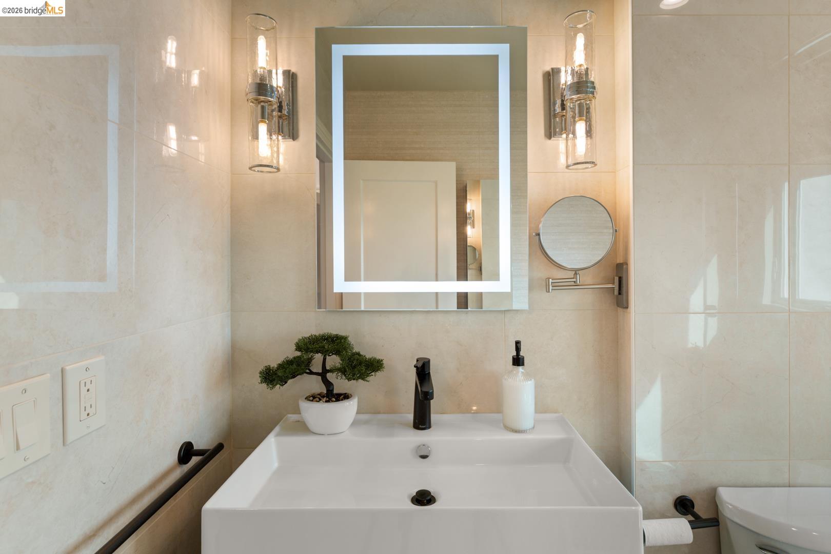 22 Windsor Avenue Kensington, CA 94708 - Photo 22 of 30 a bathroom with a sink vanity and mirror