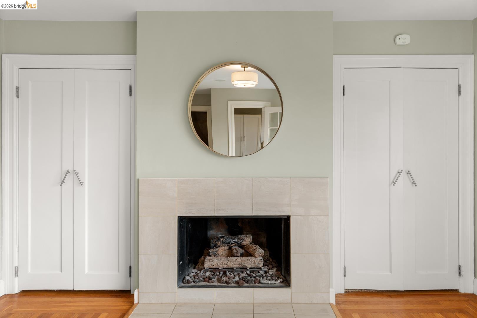22 Windsor Avenue Kensington, CA 94708 - Photo 24 of 30 a room with a fireplace and a mirror