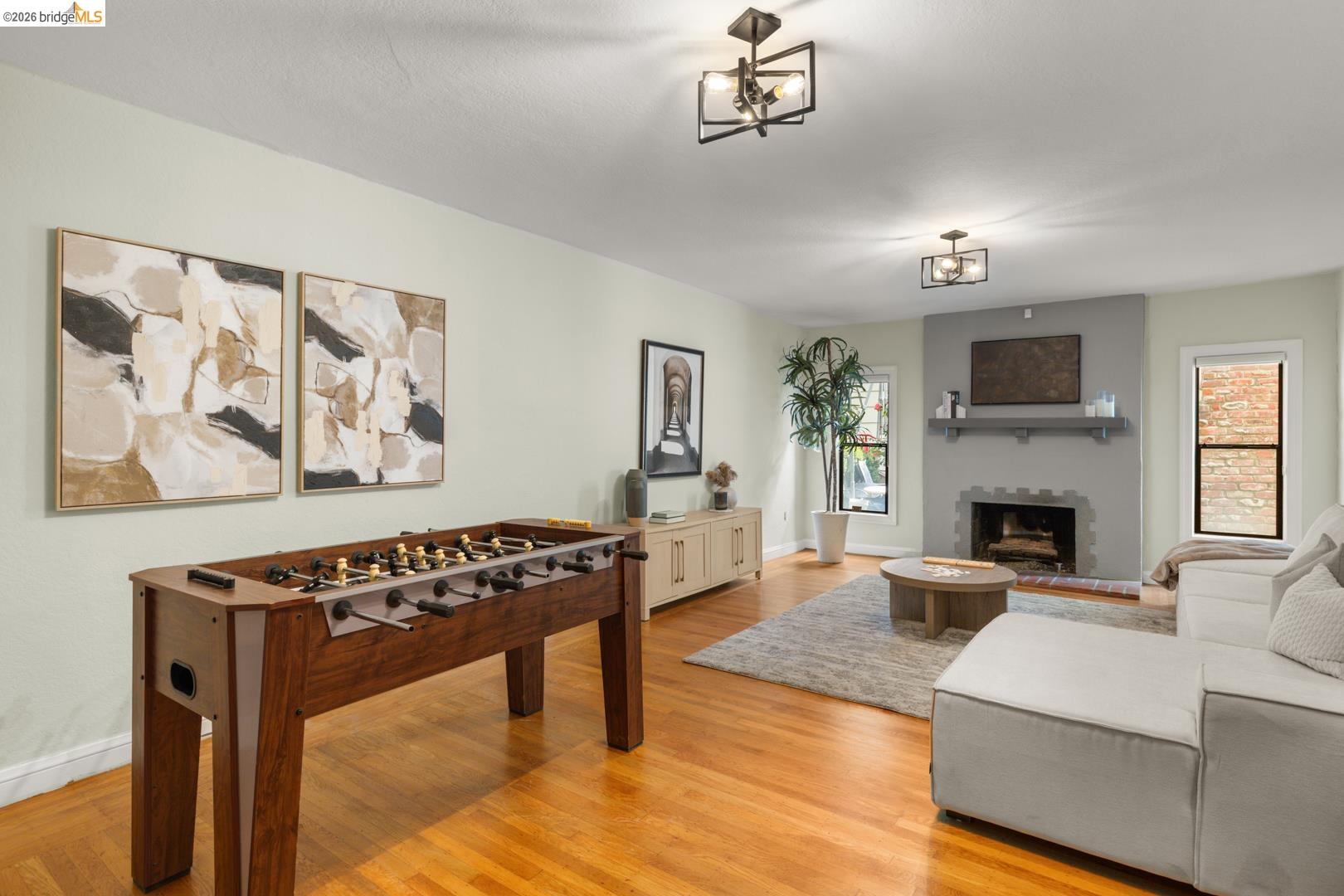 22 Windsor Avenue Kensington, CA 94708 - Photo 26 of 30 a living room with furniture a fireplace and a flat screen tv