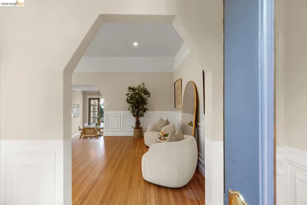 a view of living room filled with furniture and wooden floor