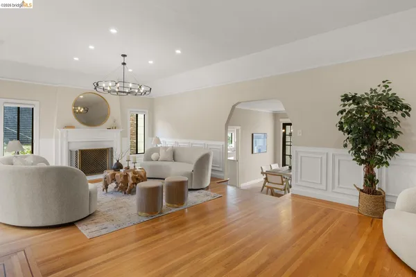 a living room with furniture a fireplace and a potted plant