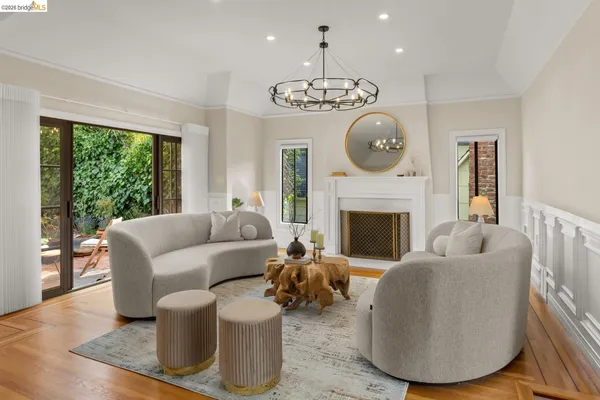 a living room with furniture a fireplace and a large window