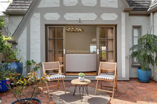 a view of a patio with table and chairs potted plants