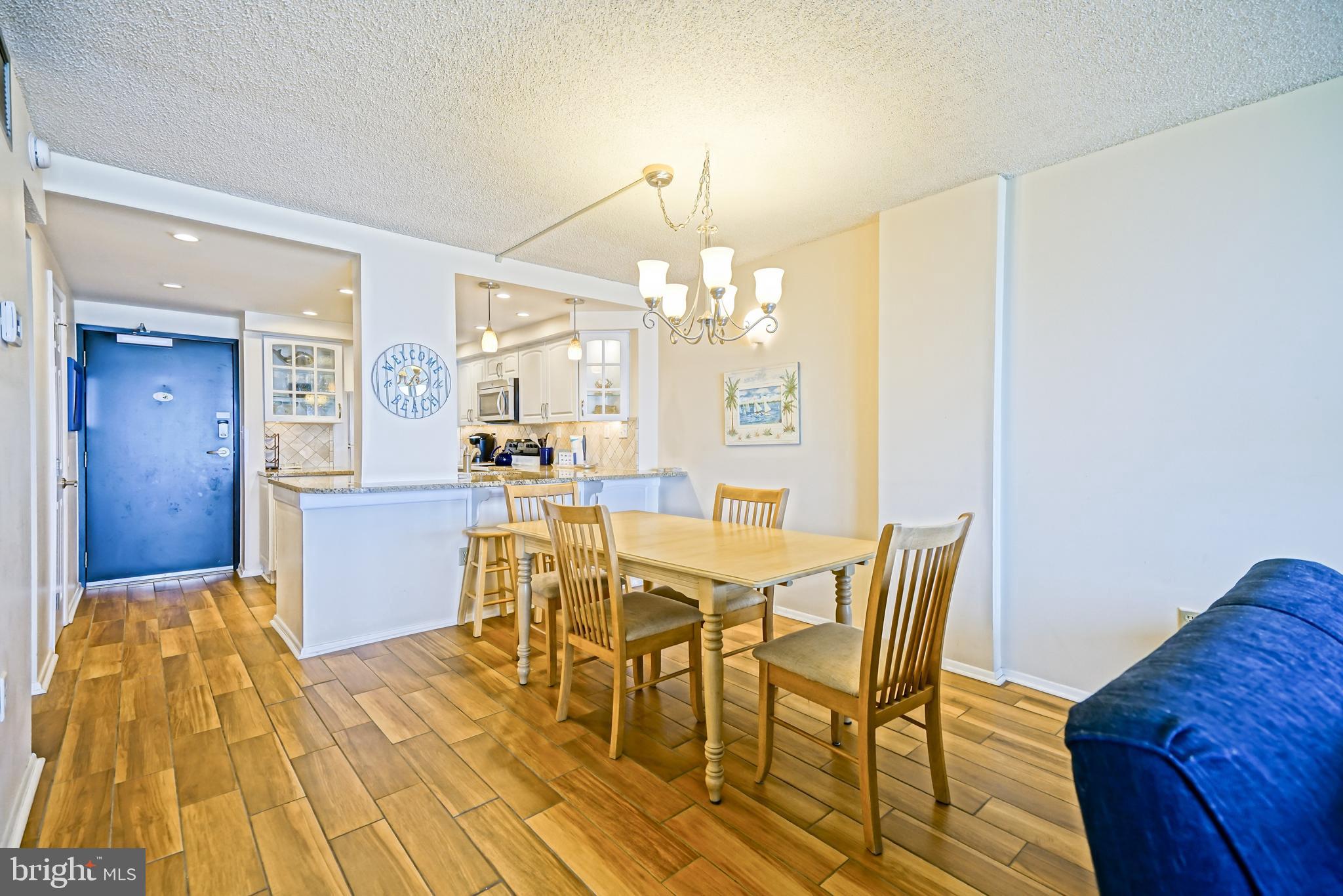 604 Dover House Road, Unit 604S Bethany Beach, DE 19930 - Photo 14 of 43 a view of a dining room with furniture and chandelier