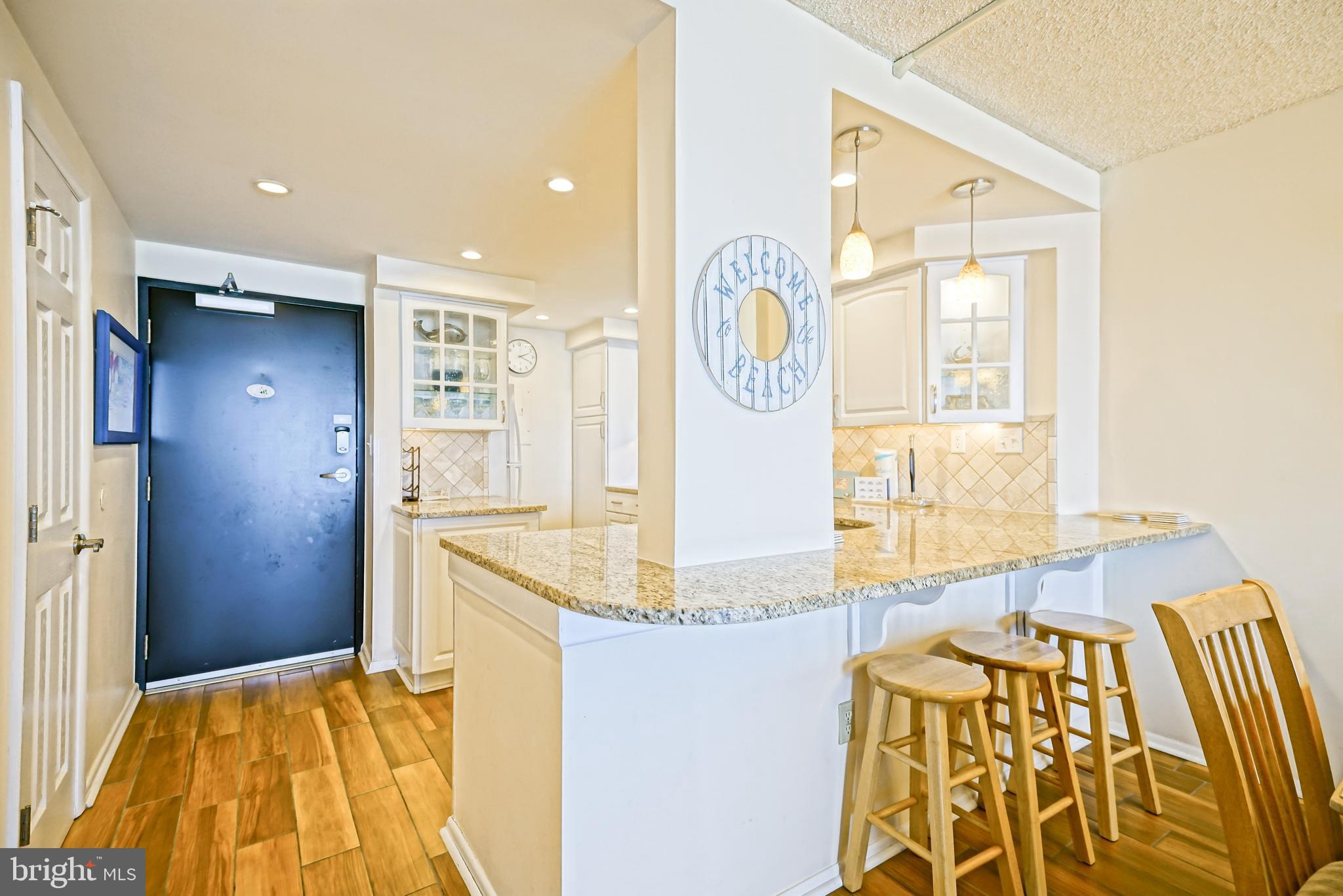 604 Dover House Road, Unit 604S Bethany Beach, DE 19930 - Photo 18 of 43 a bathroom with a granite countertop sink and a mirror