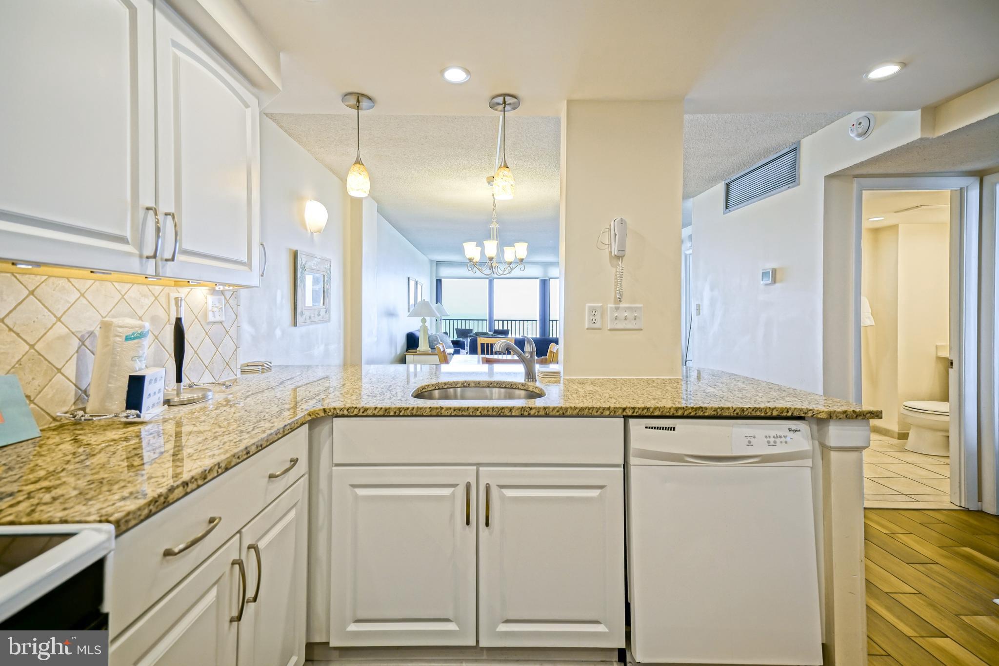 604 Dover House Road, Unit 604S Bethany Beach, DE 19930 - Photo 22 of 43 a bathroom with a granite countertop sink and a mirror