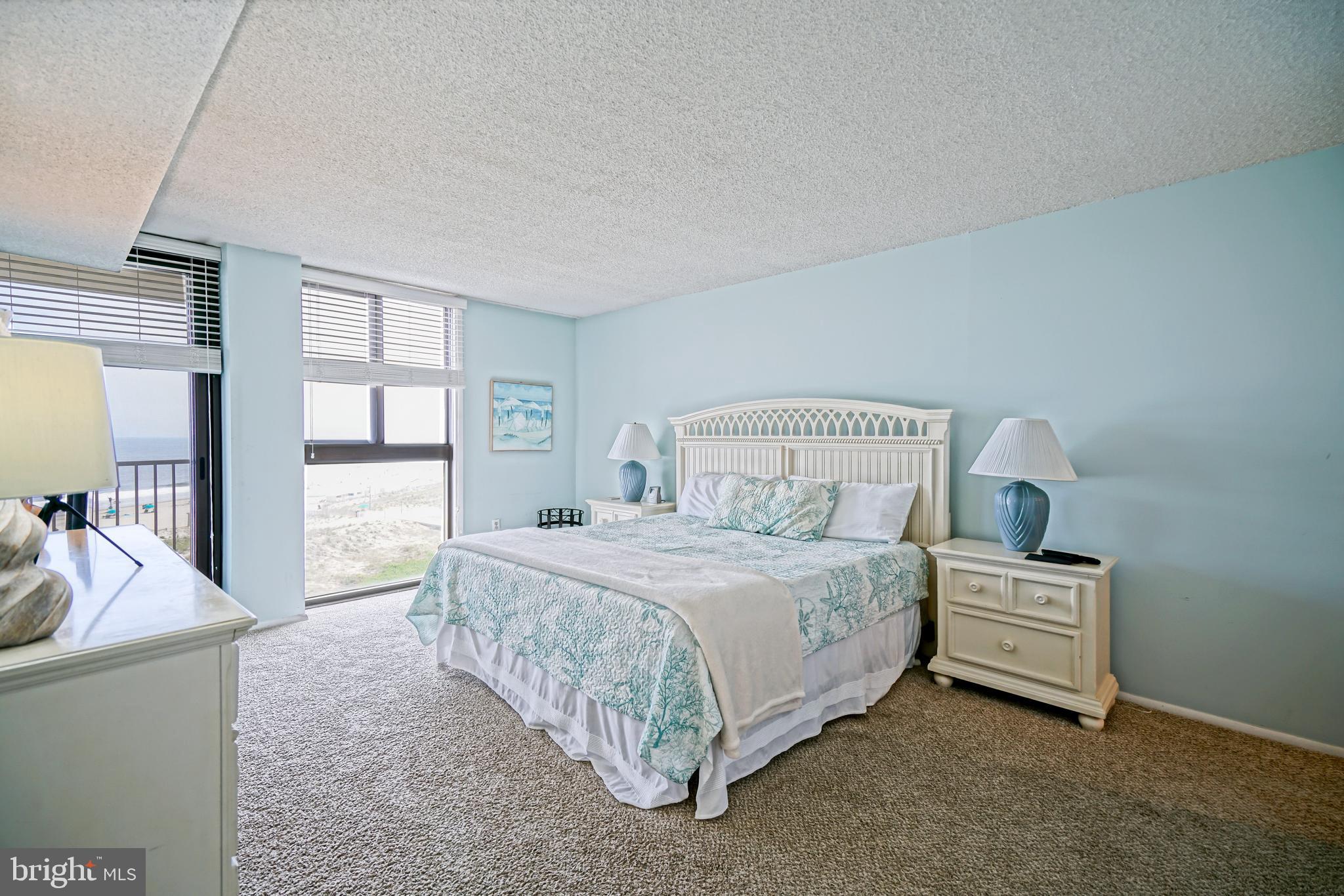 604 Dover House Road, Unit 604S Bethany Beach, DE 19930 - Photo 25 of 43 a bedroom with a bed and large windows