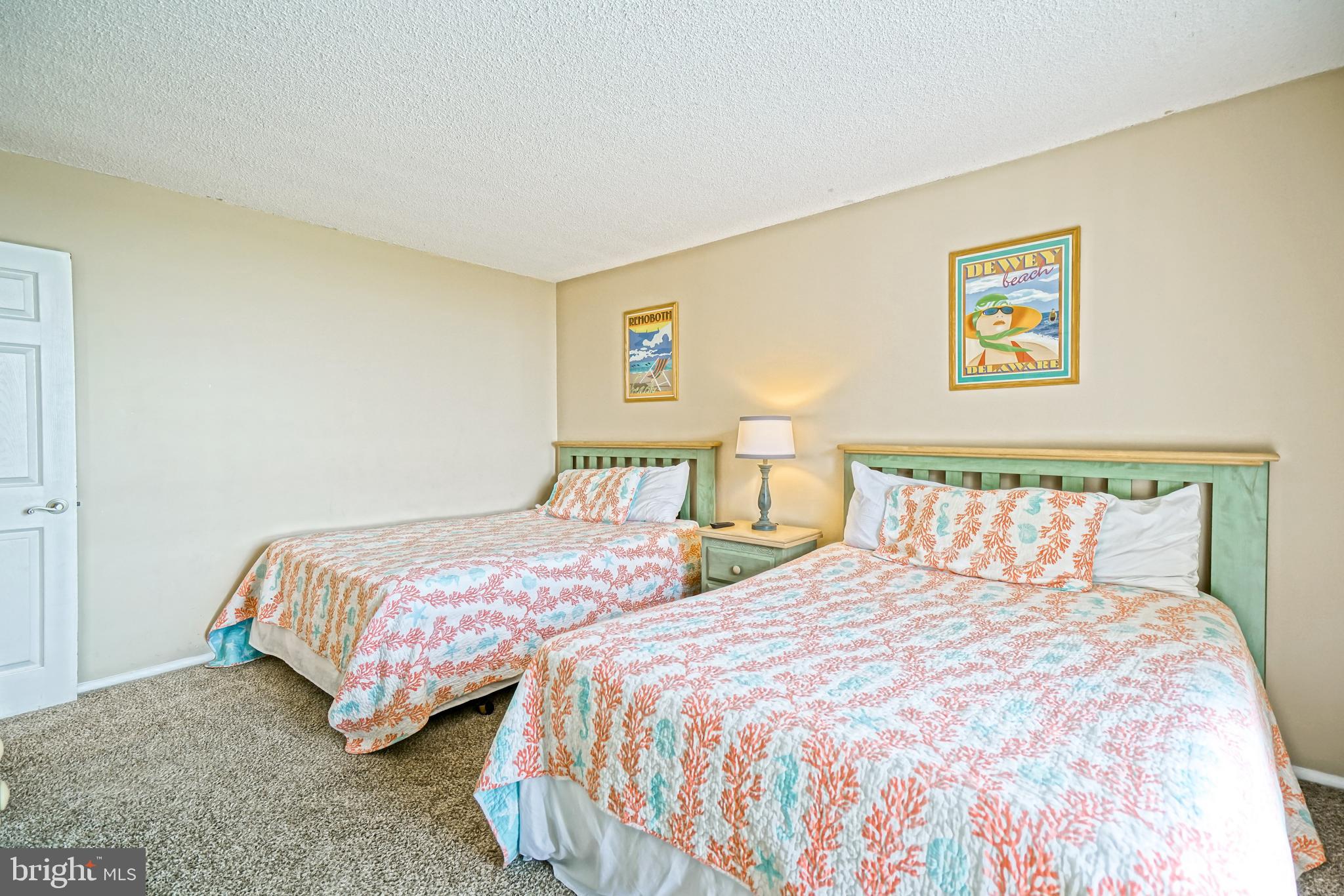 604 Dover House Road, Unit 604S Bethany Beach, DE 19930 - Photo 32 of 43 a bedroom with two beds and a night stand