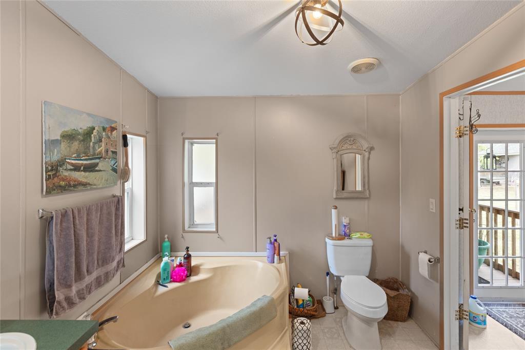 5670 Acadia Street Keystone Heights, FL 32656 - Photo 38 of 65 a bathroom with a sink toilet and a mirror
