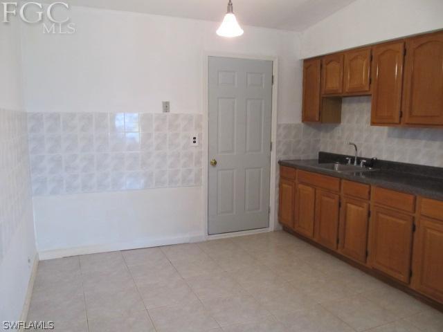 2164 Mangrove Road Punta Gorda, FL 33982 - Photo 10 of 21 a bathroom with a granite countertop sink a toilet and bathtub
