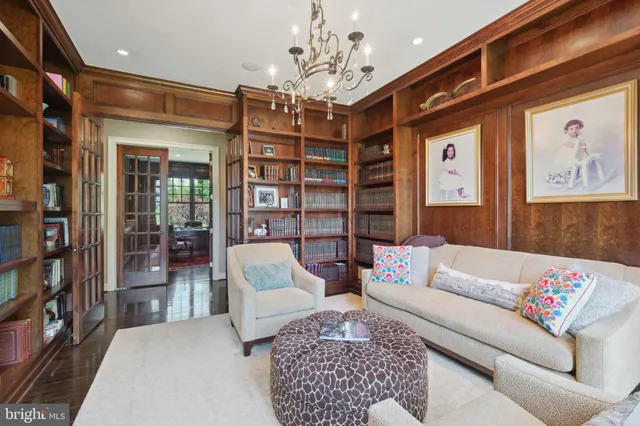 a bedroom with a large bed and a flat tv screen on dresser