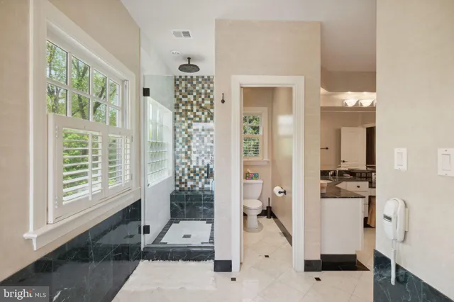 a view of a house with couches chairs and wooden floor
