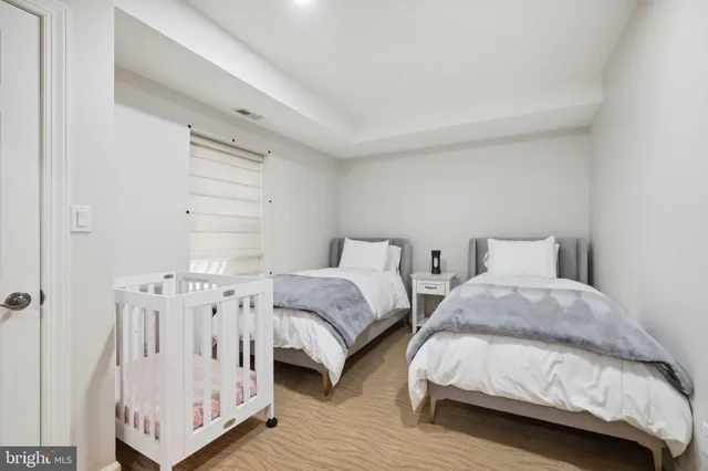 a view of a house with a yard and potted plants