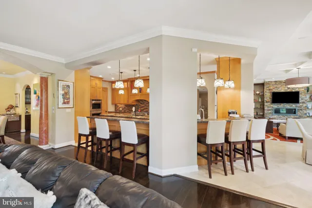 a kitchen with stainless steel appliances granite countertop a stove a sink and a granite counter tops with wooden floors