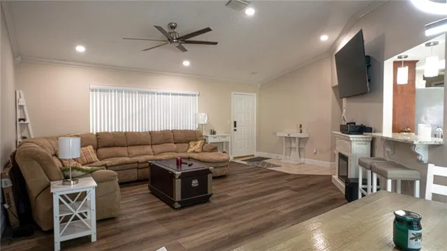 a living room with furniture a fireplace and a flat screen tv