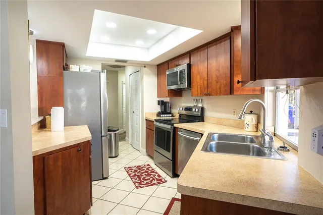 a kitchen with stainless steel appliances granite countertop a refrigerator and a stove