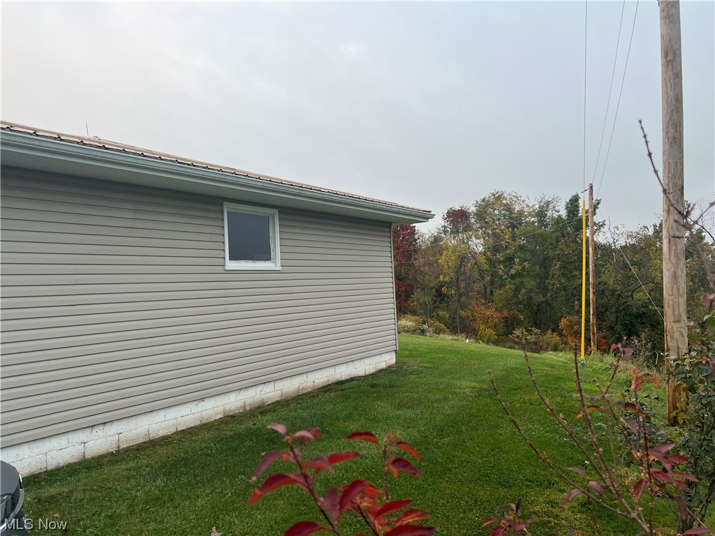 52995 Cash Ridge Road Shadyside, OH 43947 - Photo 23 of 32 View of property exterior featuring a yard