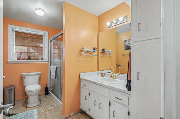 a bathroom with a granite countertop sink toilet and shower