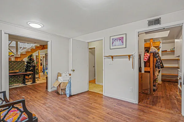 a view of a livingroom with wooden floor and a ceiling fan