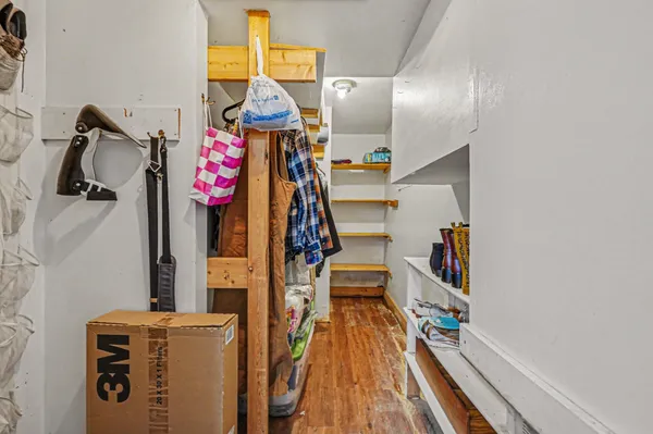 a utility room with fridge dryer and bicycles