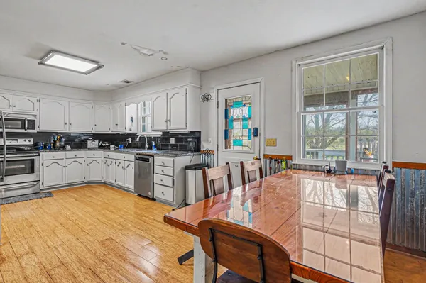 a kitchen with stainless steel appliances granite countertop a refrigerator sink and stove