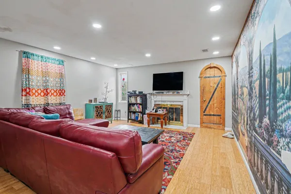 a living room with furniture a fireplace and a flat screen tv