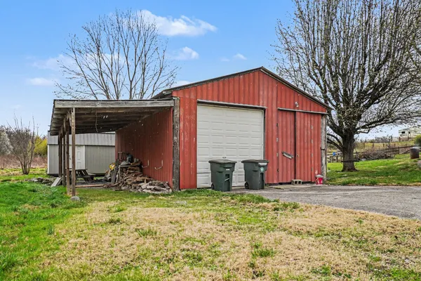 a view of a house with a yard and sitting area