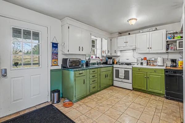 a kitchen with sink cabinets and window