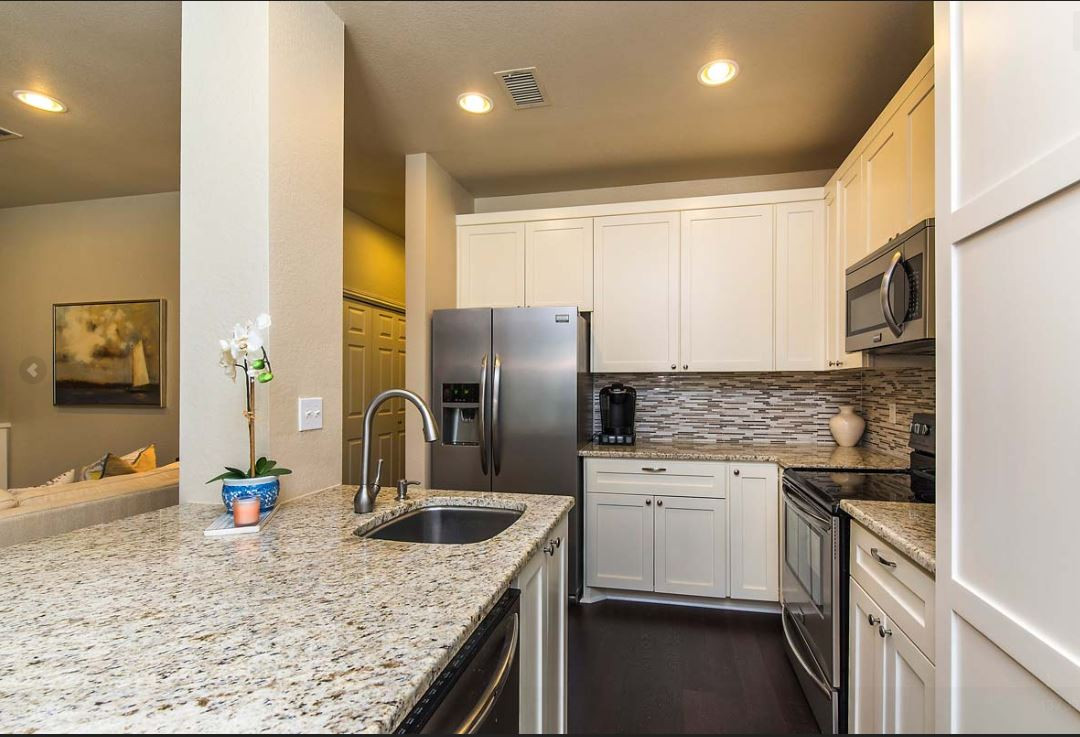 2508 Enfield Road, Unit 11 Austin, TX 78703 - Photo 2 of 8 a kitchen with stainless steel appliances granite countertop a sink stove and refrigerator