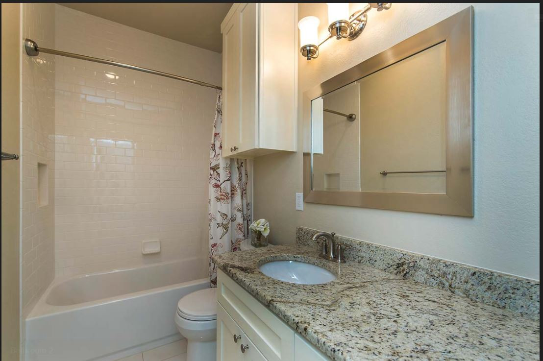 2508 Enfield Road, Unit 11 Austin, TX 78703 - Photo 4 of 8 a bathroom with a granite countertop sink toilet and shower