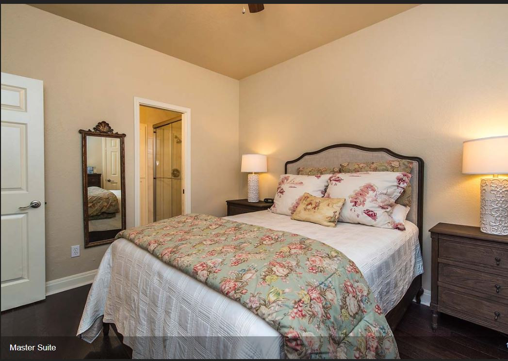 2508 Enfield Road, Unit 11 Austin, TX 78703 - Photo 5 of 8 a bedroom with a bed and a lamp