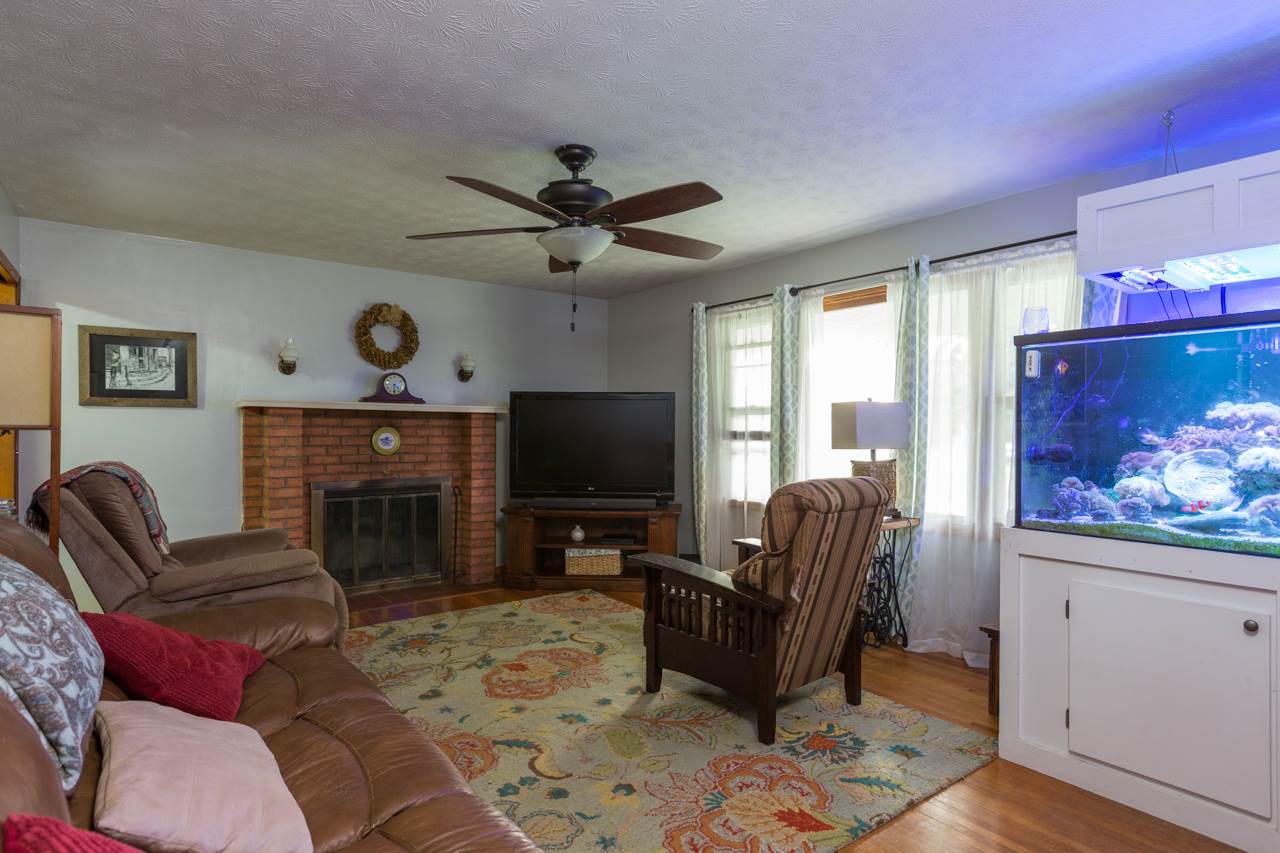 2439 Fairview Road Mount Crawford, VA 22841 - Photo 6 of 27 A spacious 13x18 living room with wood burning fireplace and hardwood floors.
