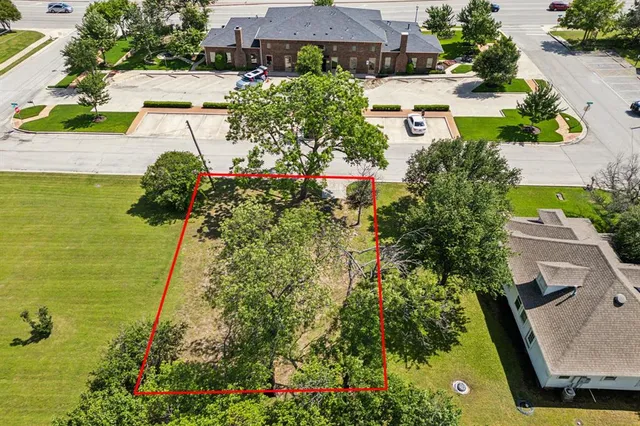 an aerial view of residential houses with outdoor space and swimming pool