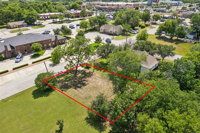 an aerial view of residential houses with outdoor space and swimming pool