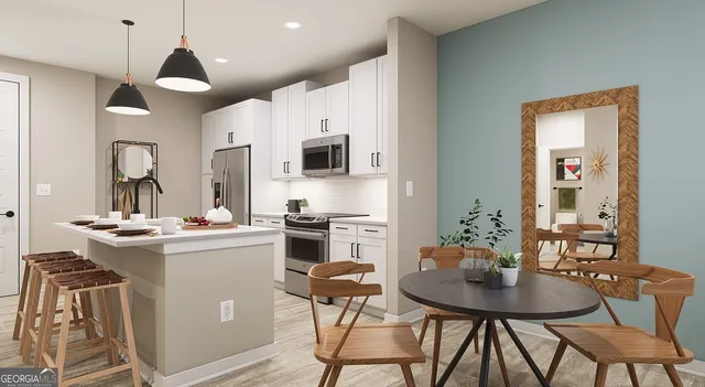 a kitchen with stainless steel appliances kitchen island a table and chairs in it