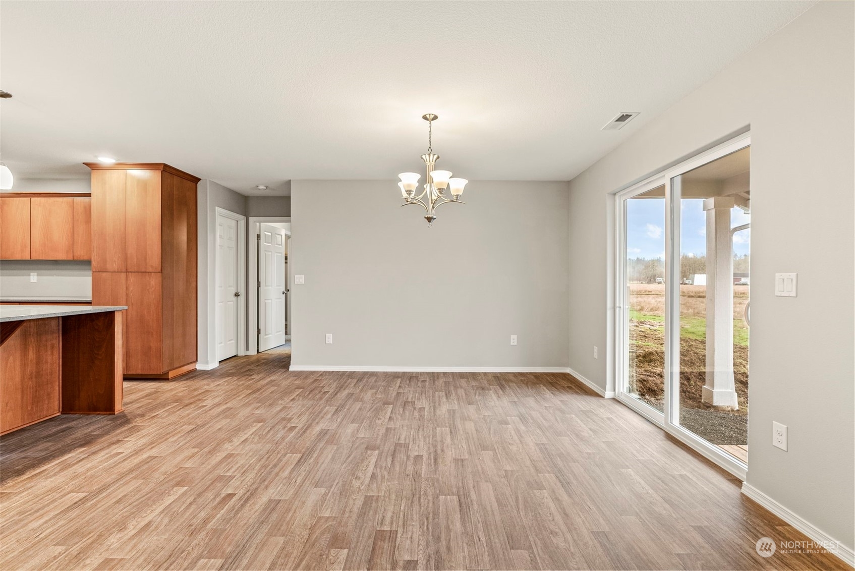607 Tauscher Road Chehalis, WA 98532 - Photo 10 of 25 a view of an empty room with wooden floor and a window