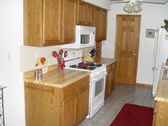 5863 Rural Edge Drive Roscoe, IL 61073 - Photo 3 of 11 a kitchen with stainless steel appliances a stove a sink and a refrigerator