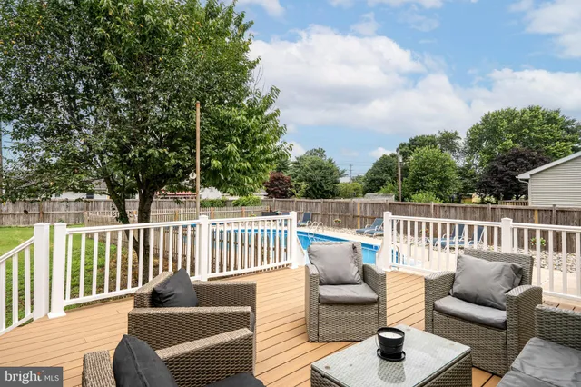 a balcony with wooden floor and furniture