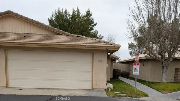 a small white house with outdoor space