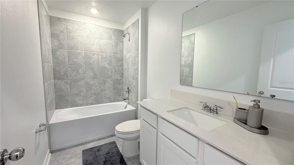 1179 Tyler Loop Lake Wales, FL 33859 - Photo 14 of 25 a bathroom with a sink a toilet and shower