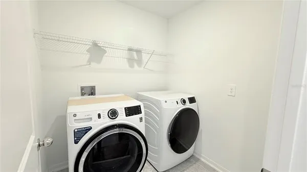 a view of storage and utility room with washer and dryer