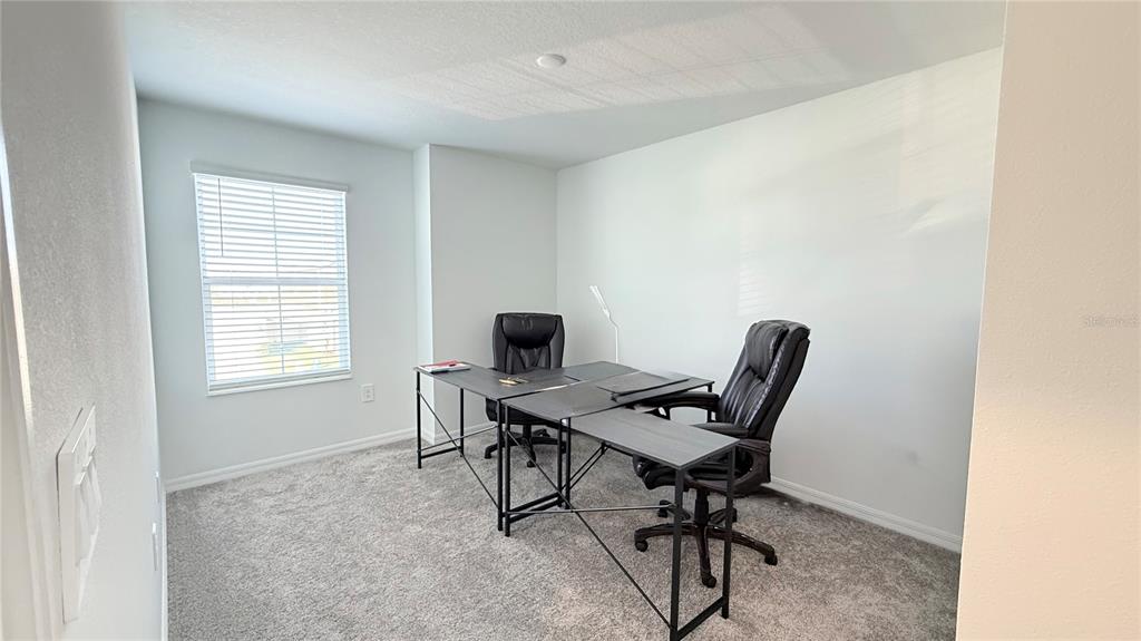 1179 Tyler Loop Lake Wales, FL 33859 - Photo 17 of 25 a view of a workspace with furniture and a window
