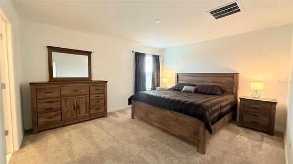 a bedroom with a bed and dresser