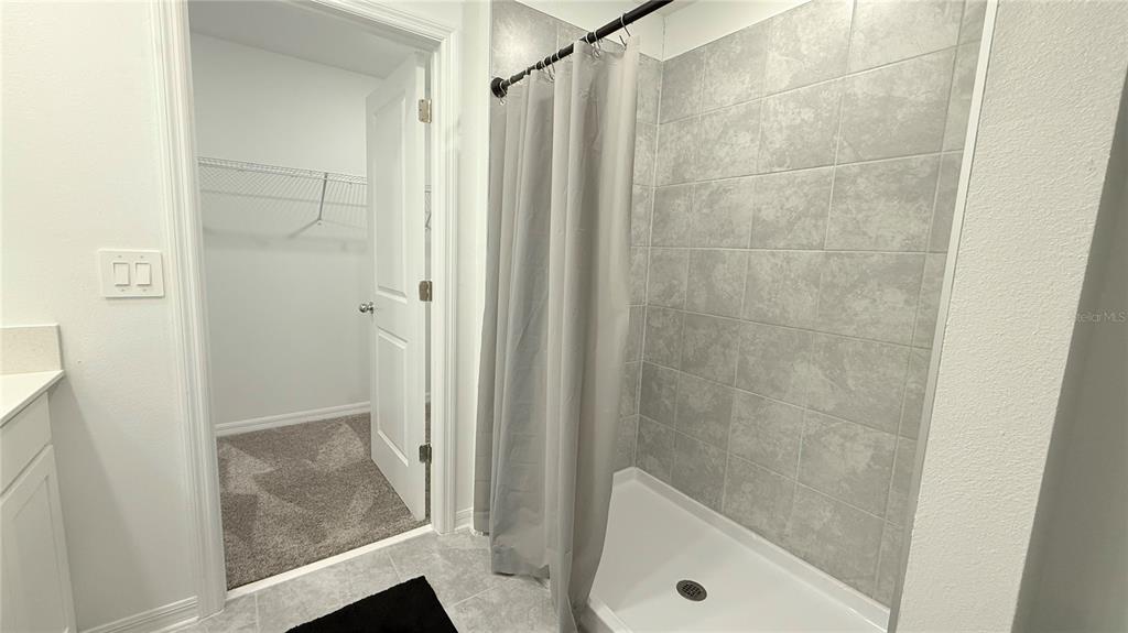 1179 Tyler Loop Lake Wales, FL 33859 - Photo 21 of 25 a bathroom with a tub and shower