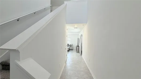 a view of a hallway with white walls