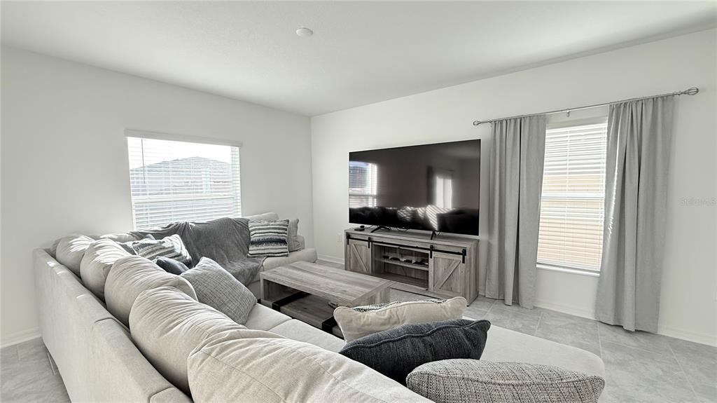 1179 Tyler Loop Lake Wales, FL 33859 - Photo 5 of 25 a living room with furniture and a flat screen tv